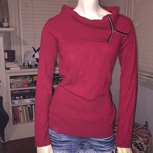 Red sweater with zippered cowl neck.